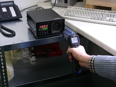 Calibrators calibrating an infrared thermometer.
