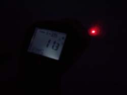 Infrared Thermometer measuring with an infrared thermometer in darkness.