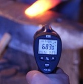 Infrared thermometers: infrared thermometer being used to test the temperature of an automobile engine