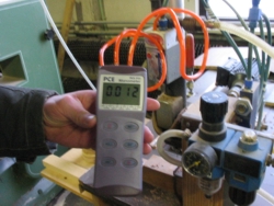 The PCE-P15 Differential Pressure Meter measuring differential pressure of a machine's motor