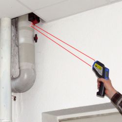Here is an infrared thermometer measuring the temperature of a heating unit.