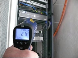 Infrared Thermometer testing the temperature of a manhole.