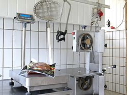 Water resistant industrial balance being used at a butcher's shop.