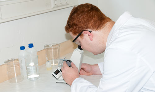 Laboratory assistant while doing research with the Abbe refractometer