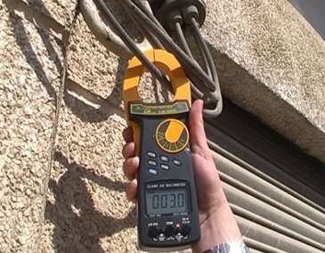 The CM-9930eff current detector being used in a building.