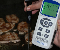 Testing the temperature in a grill with the PCE-T 395 digital thermometer.