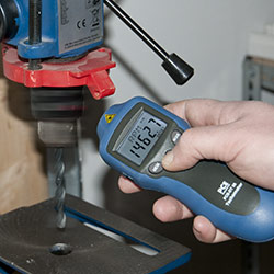 The High Precision Optical Tachometer PCE-DT 65 measuring a drilling machine contact-free.